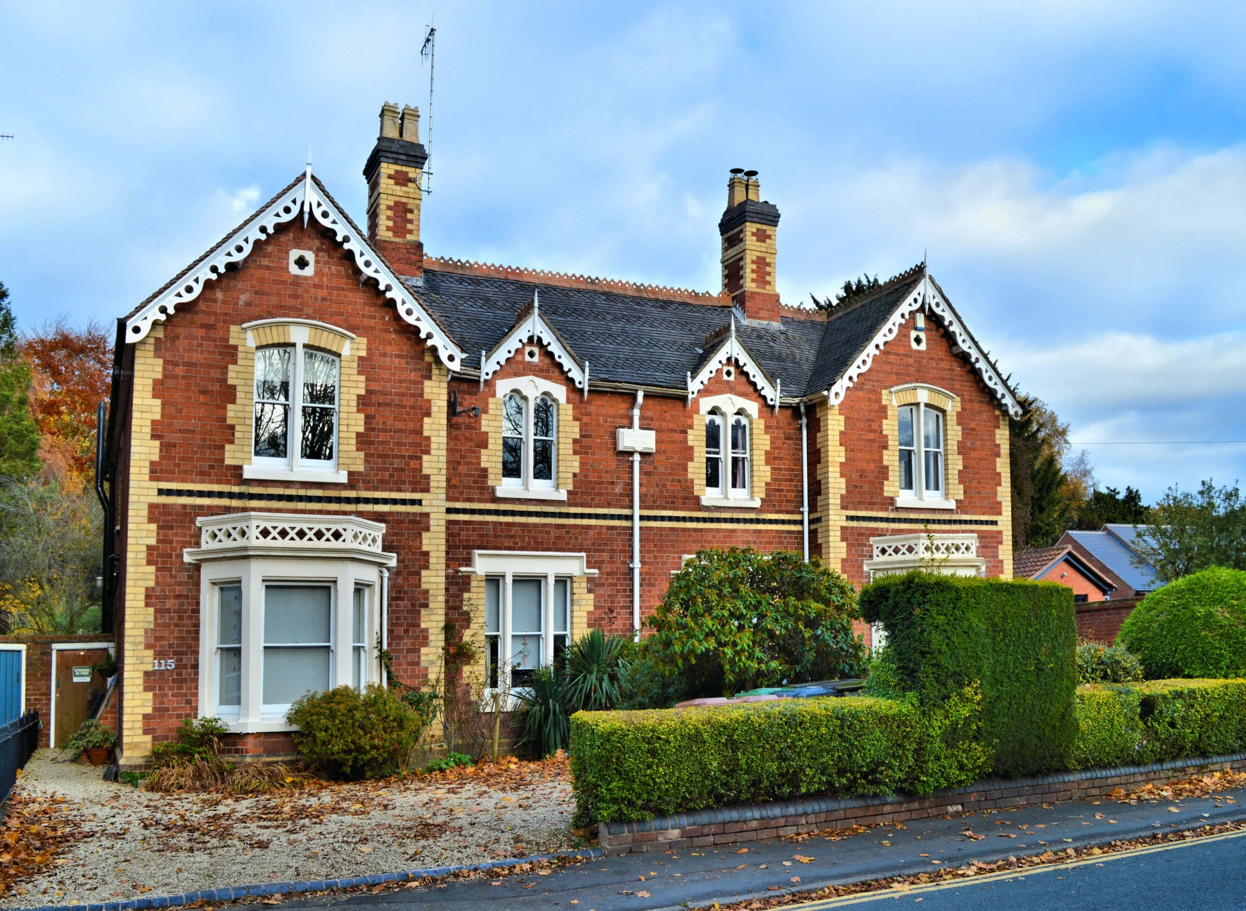 Victorian red-brick homes with decorative gables and chimney stacks